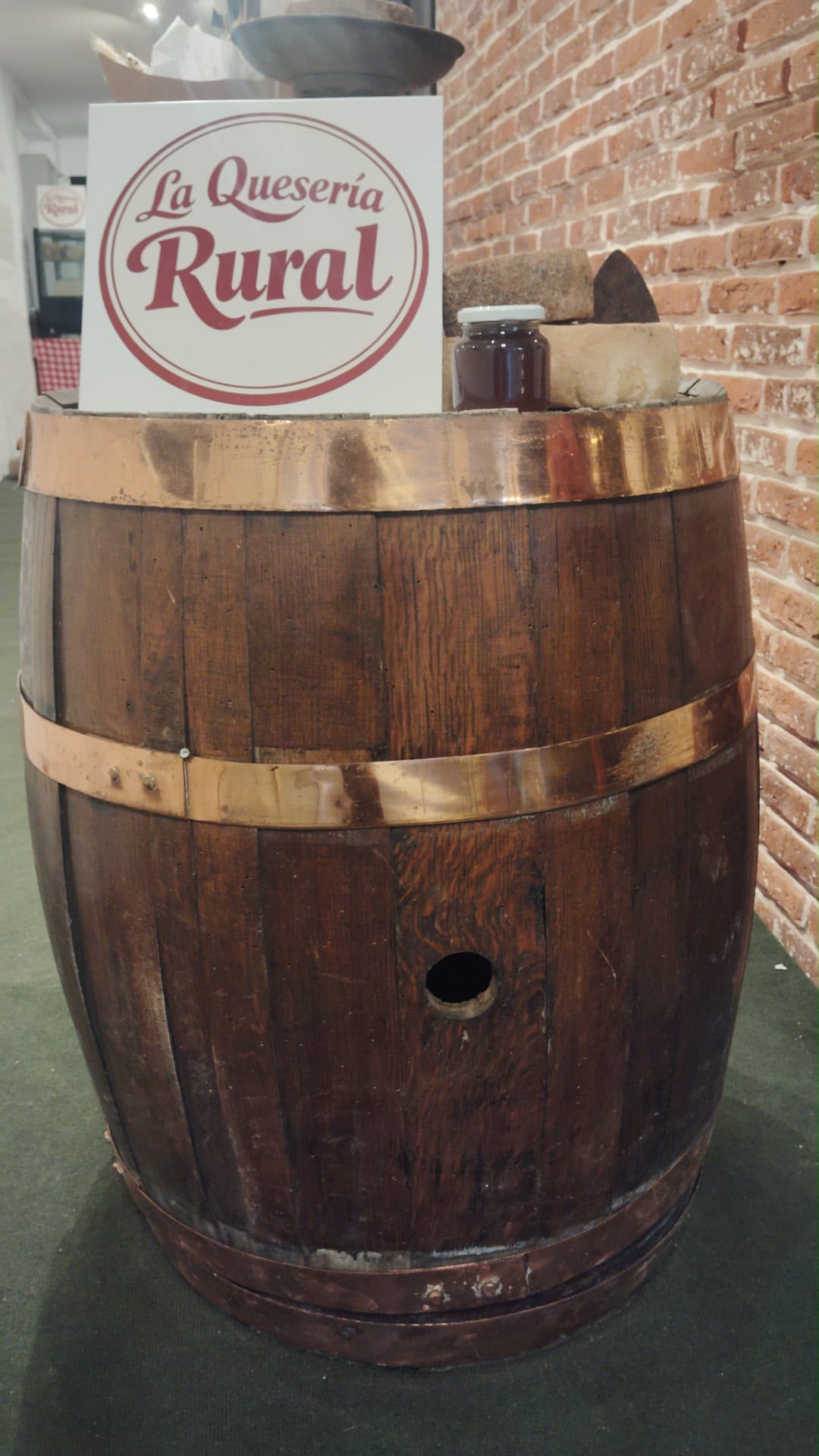 Barril de madera con el logo de La Queseria Rural en el local